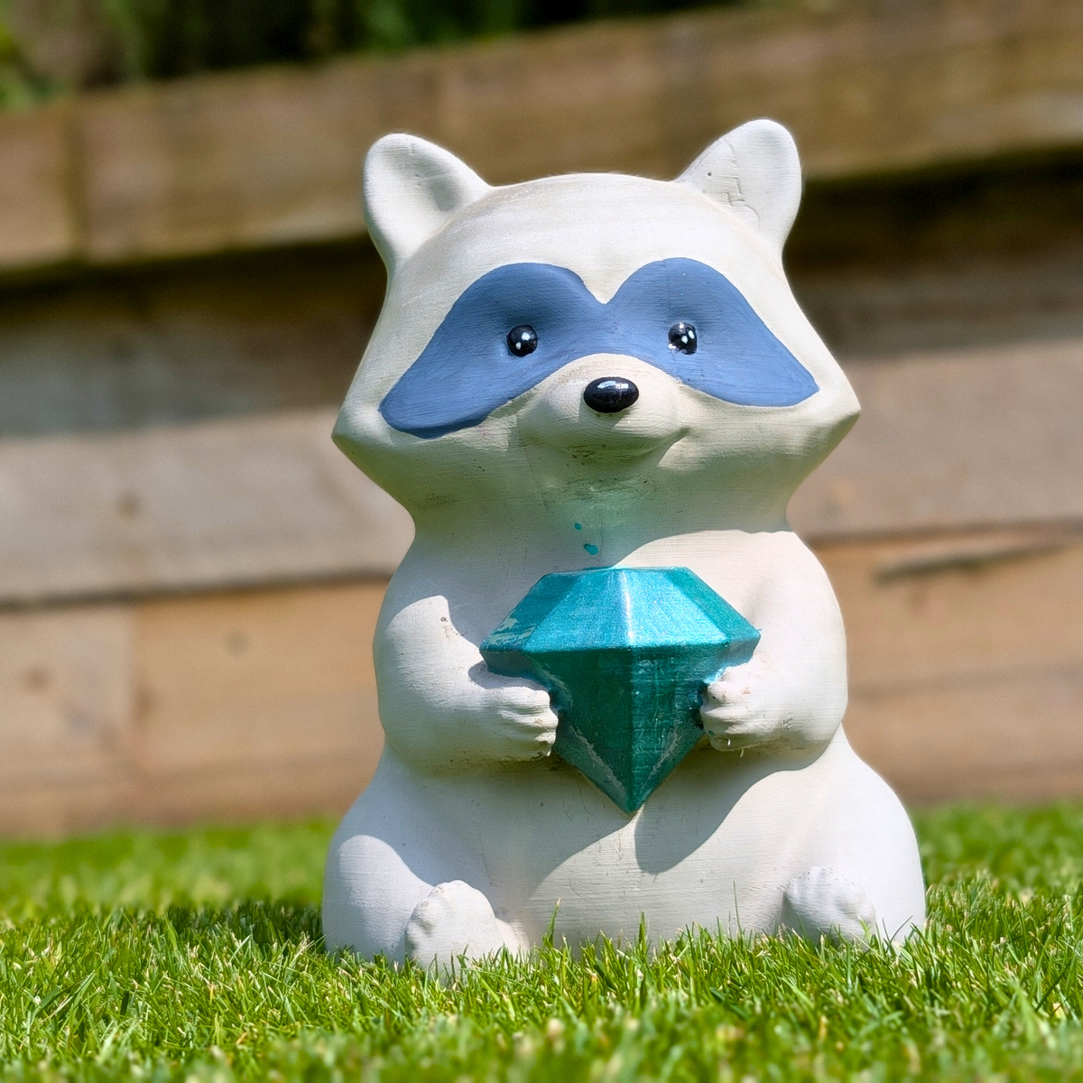 Raccoon Garden Statue displayed alongside complementary pieces