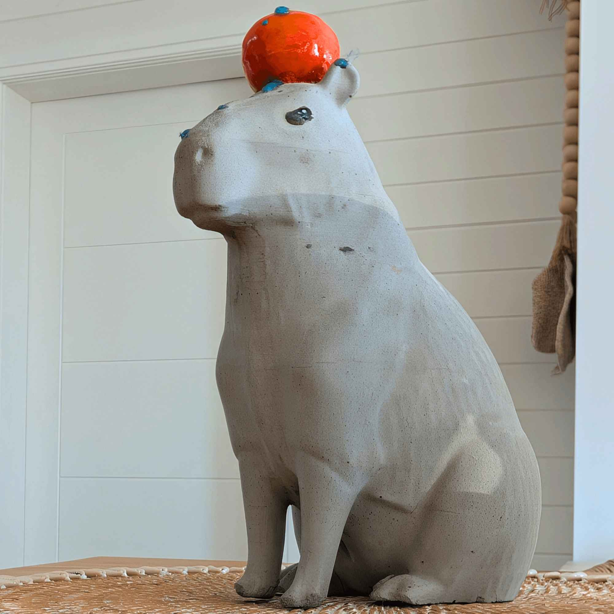Capybara with Orange Concrete Sculpture styled in home setting