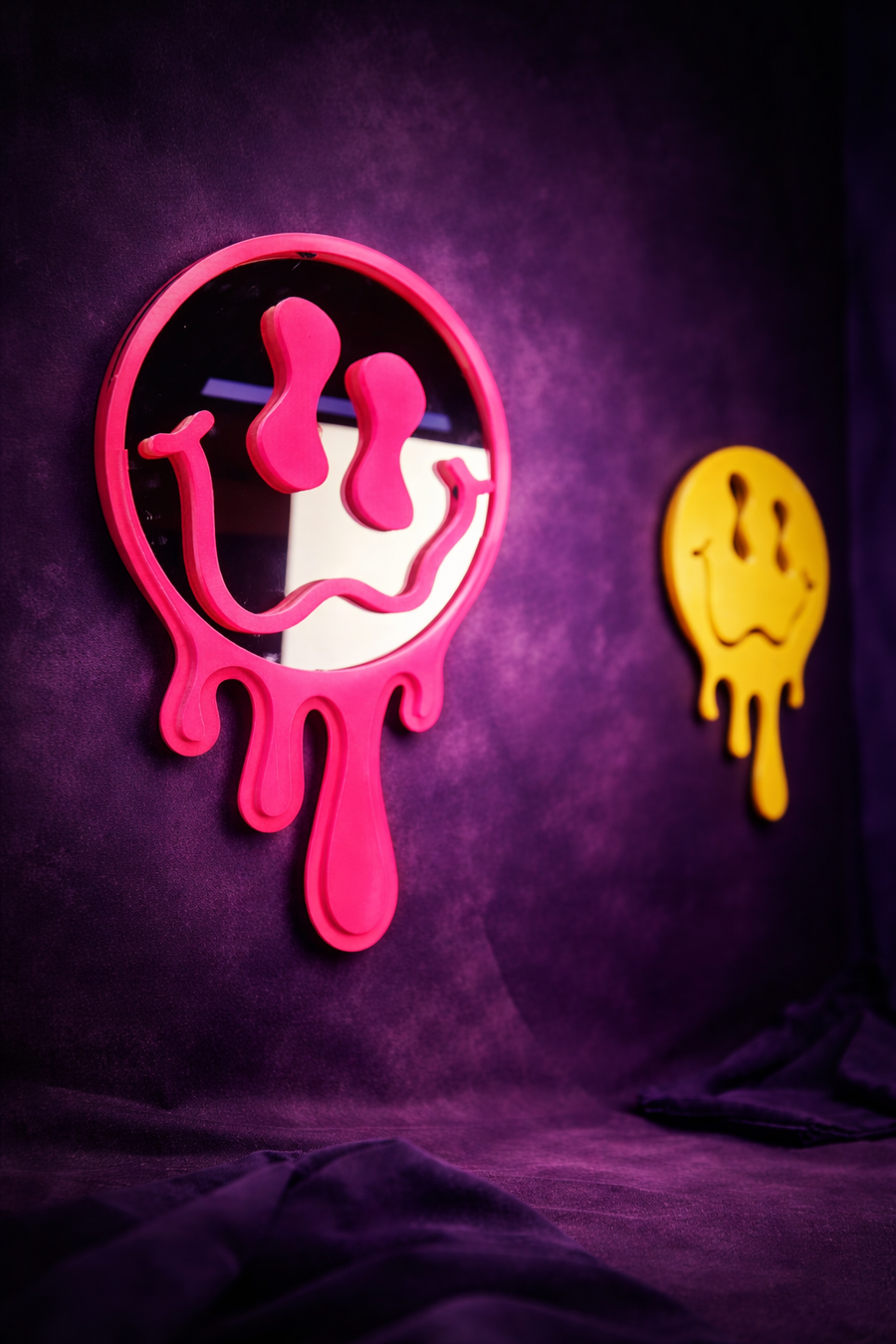 Melting face neon mirrors in pink and yellow on purple wall
