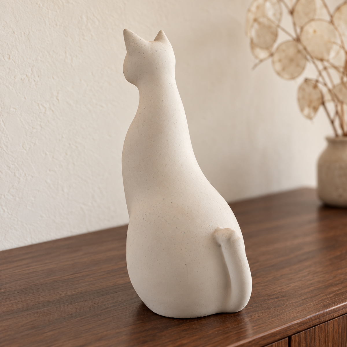 Pale modernist cat urn, rear silhouette.