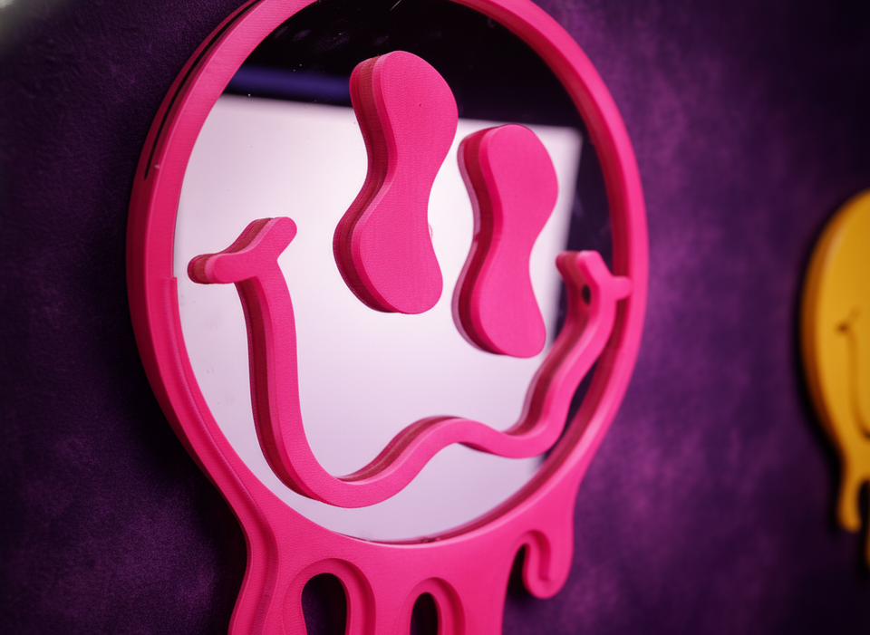 Close up detail of pink melting face mirror showing drip design