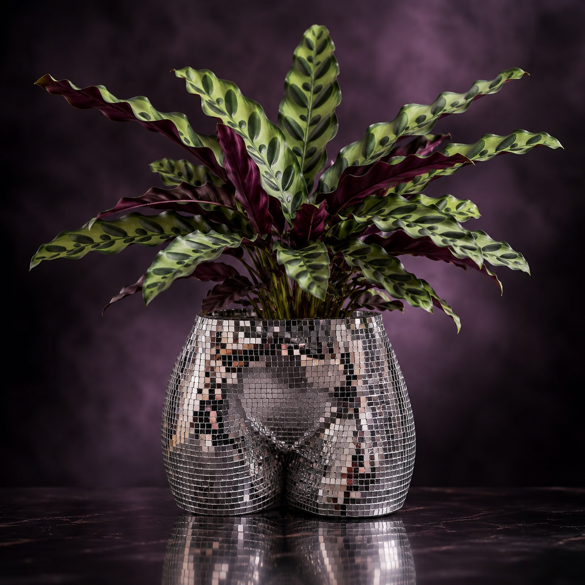 Male silver mirror tile body planter with plant against purple smoke backdrop