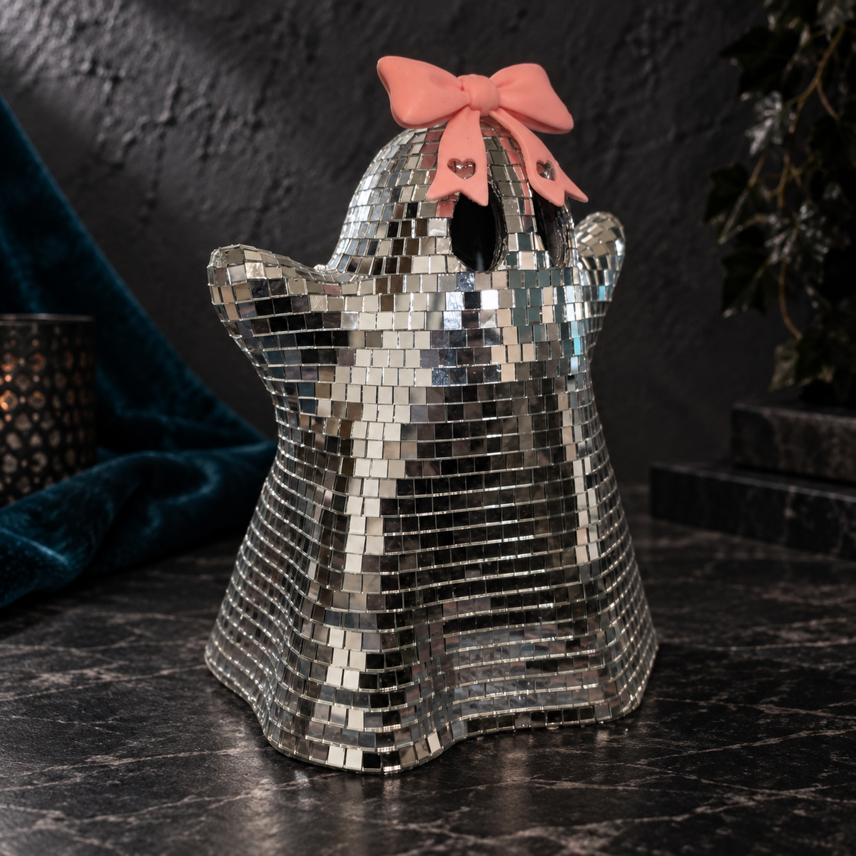 Three-quarter view of the Bow ghost, showing its raised arm, glass tile surface and flared wavy base.