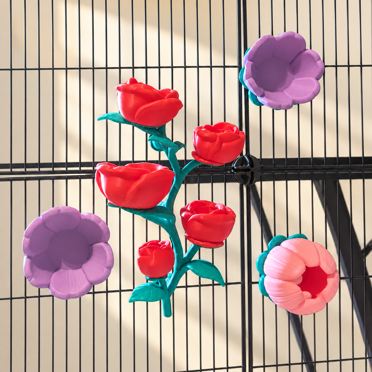 Five red rose bowls joined on one teal vine, alongside two purple flower cups and one pink cup.