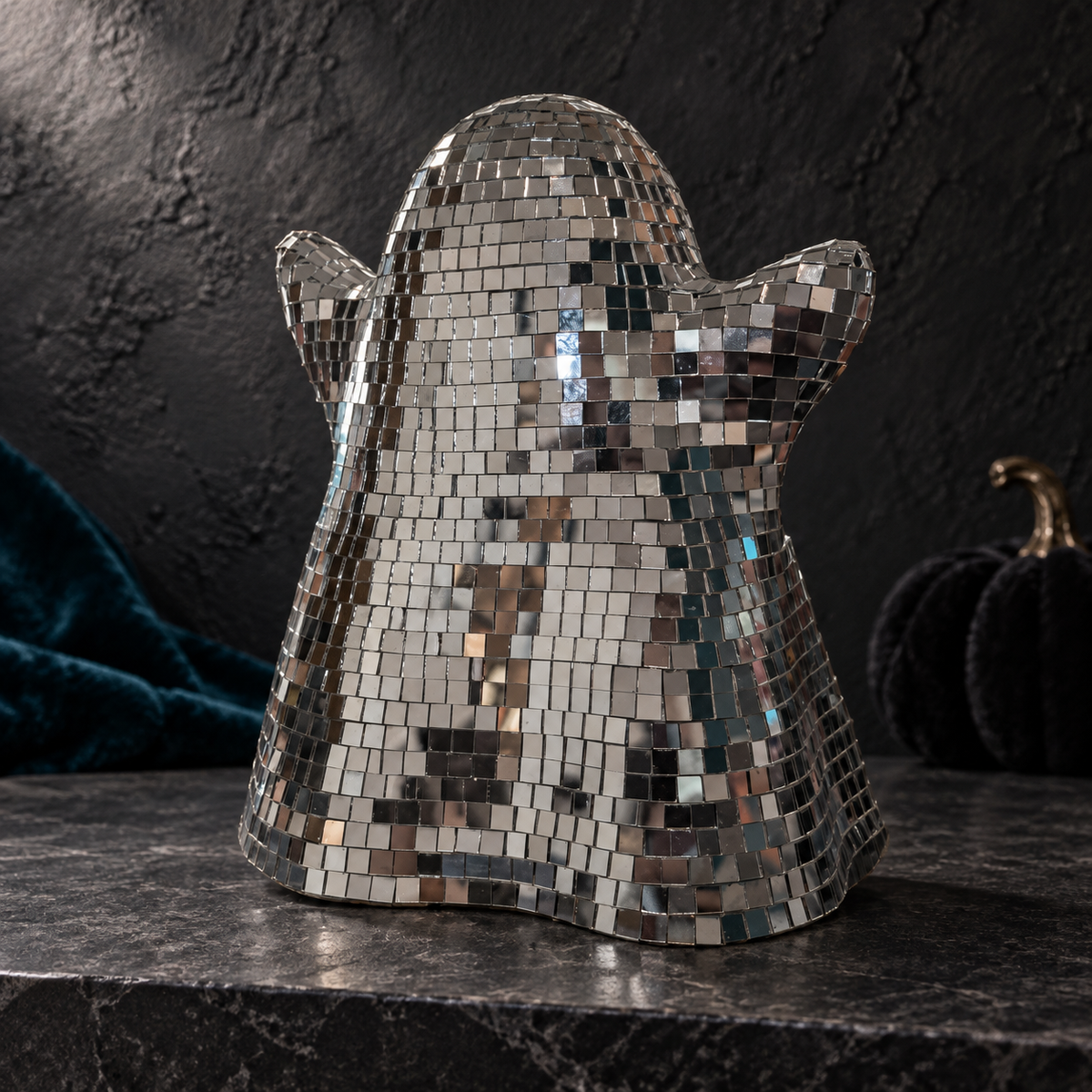 Rear view of the ghost ornament showing the glass mirror tiles over its curved back and raised arms.