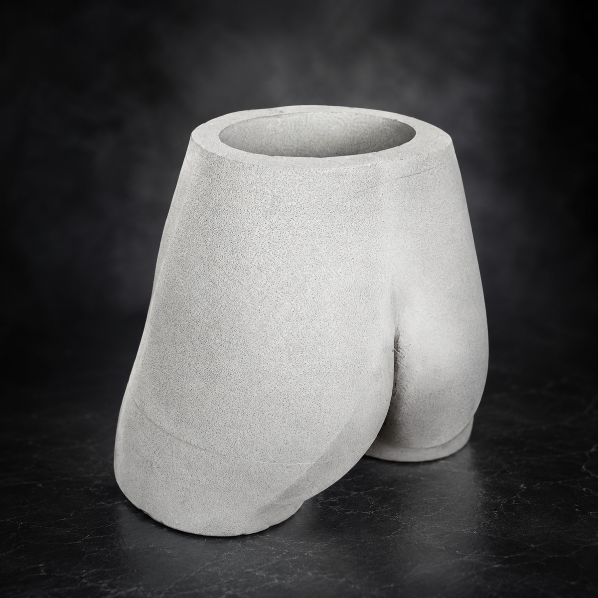 Empty Cheeky Bum cast stone planter side view showing sculpted shape
