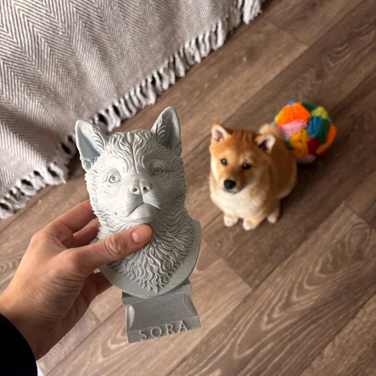 Warm Marble Grey custom dog bust held beside pet photo