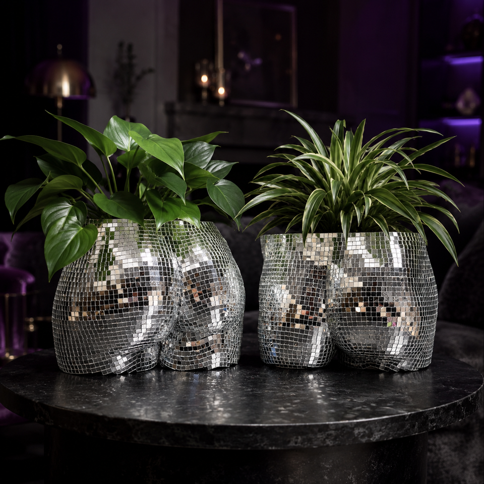 Silver disco body planters styled as statement home decor in a moody room