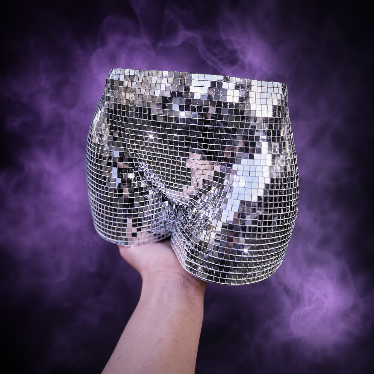 Silver disco body planter held by hand to show approximate scale