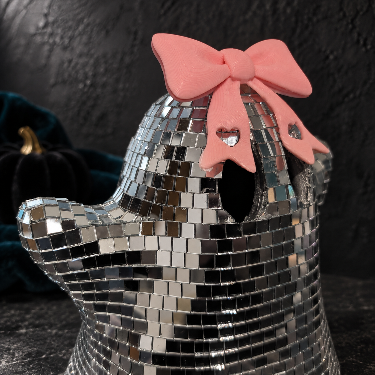 Close-up of the matte pink bow, showing its sculptural texture and heart-cutout tails.