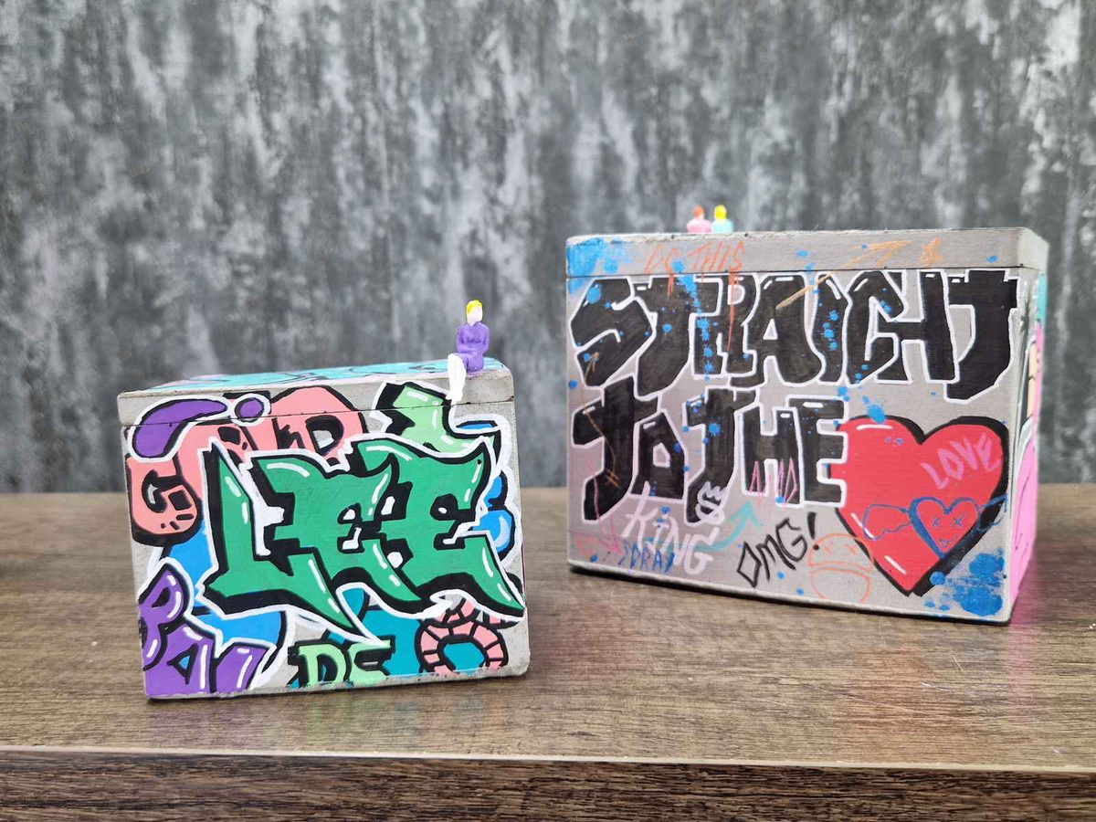 Graffiti Cast Stone Box — scale reference — shown with plant