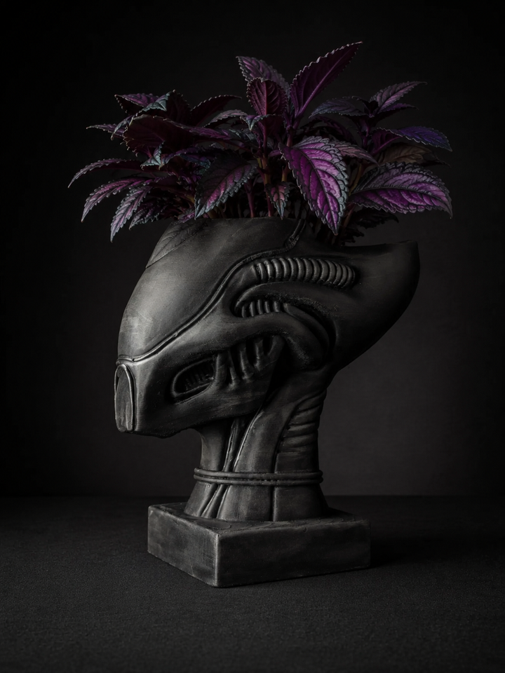 Xenophyte cast stone alien head planter with purple indoor plant