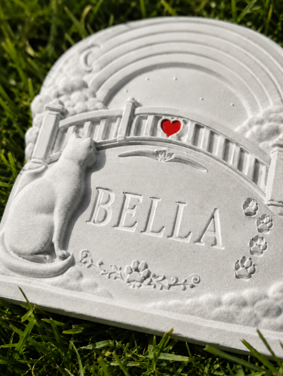 Close up of personalised Rainbow Bridge cat grave marker with name and heart detail