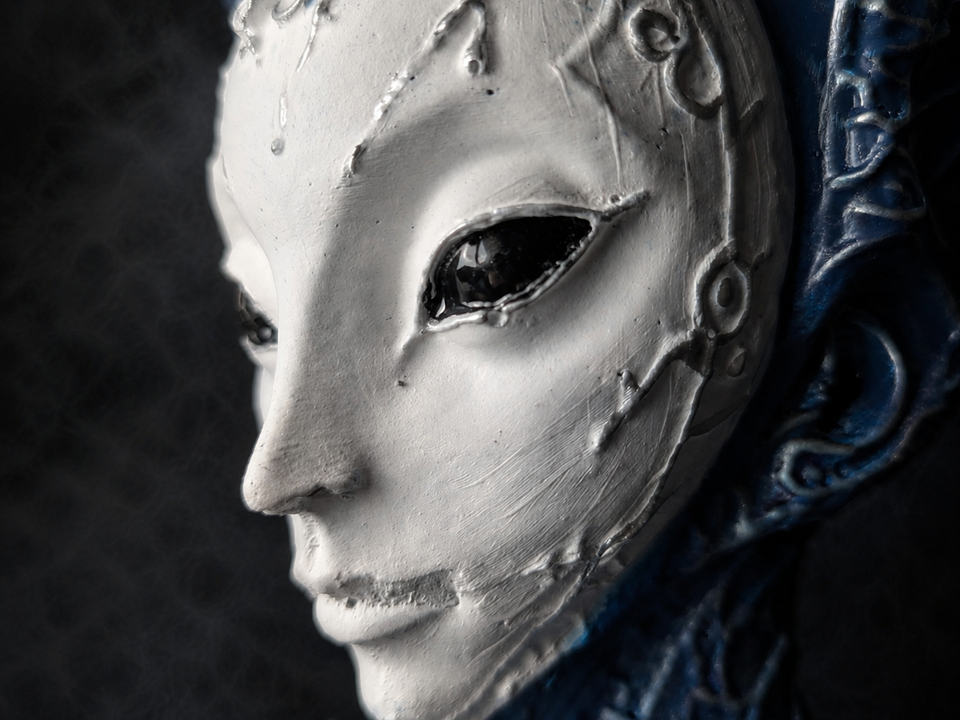 Close detail of The Blue Trickster alien planter face and blue headdress
