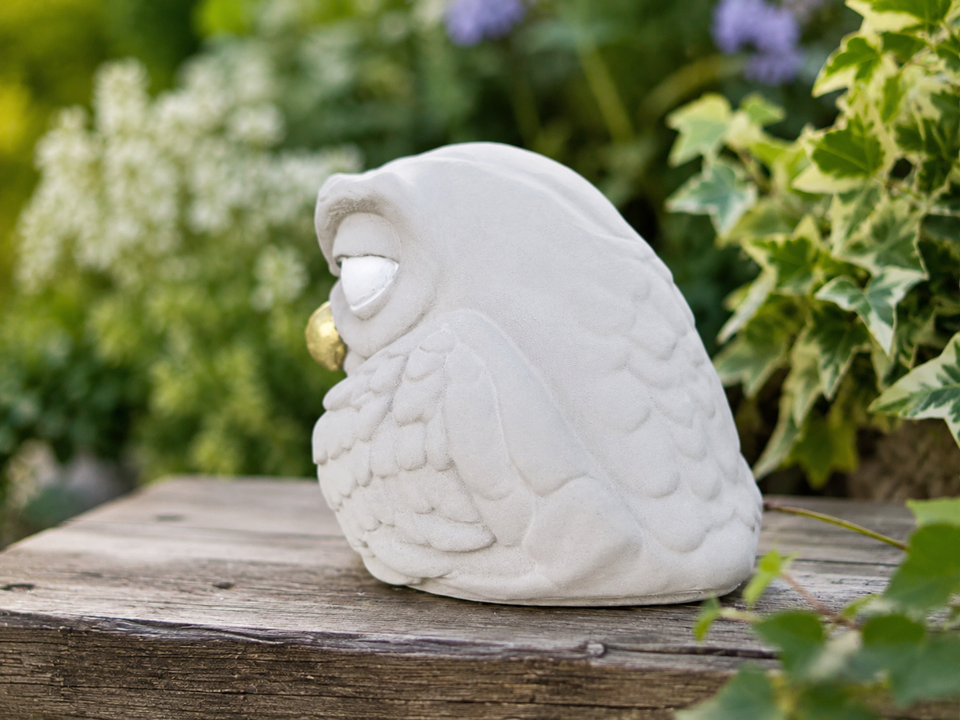 Back side view of The Little Critic owl ornament showing smooth cast stone body and feather detail