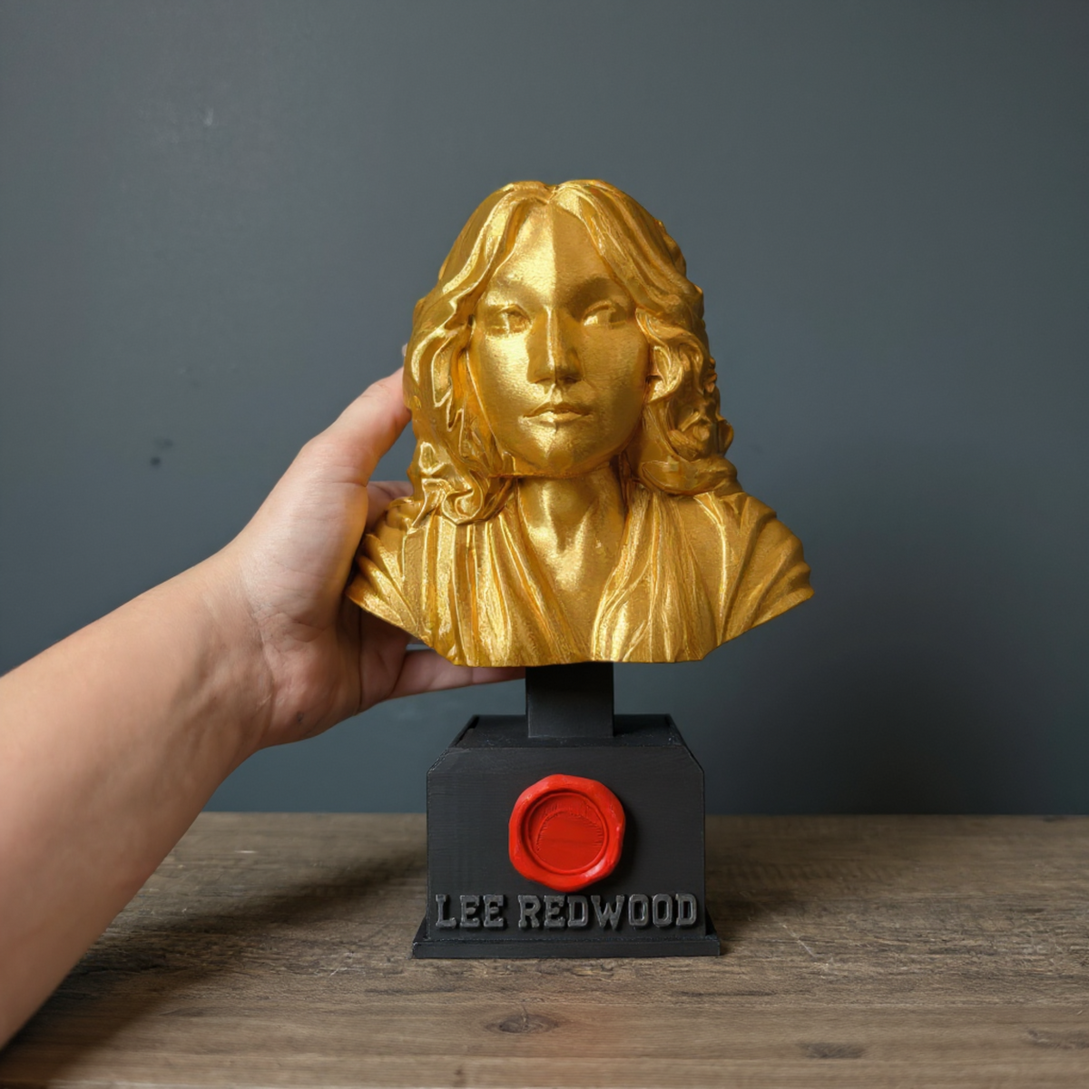 Personalised Gold Bust Trophy displayed alongside complementary pieces