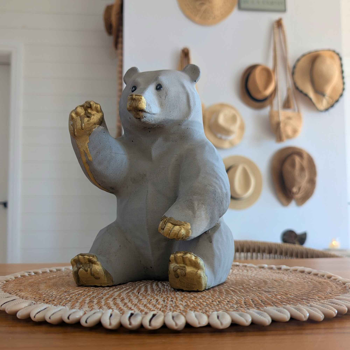 Honey bear garden ornament displayed on a woven mat indoors