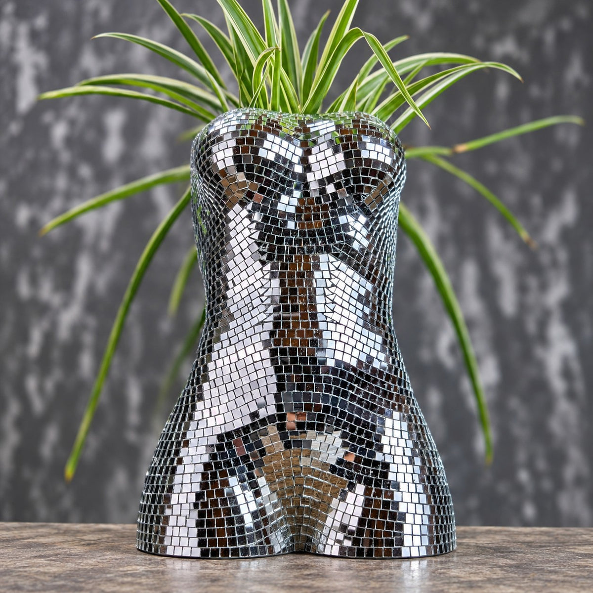 Cropped close-up of mirror torso planter with houseplant