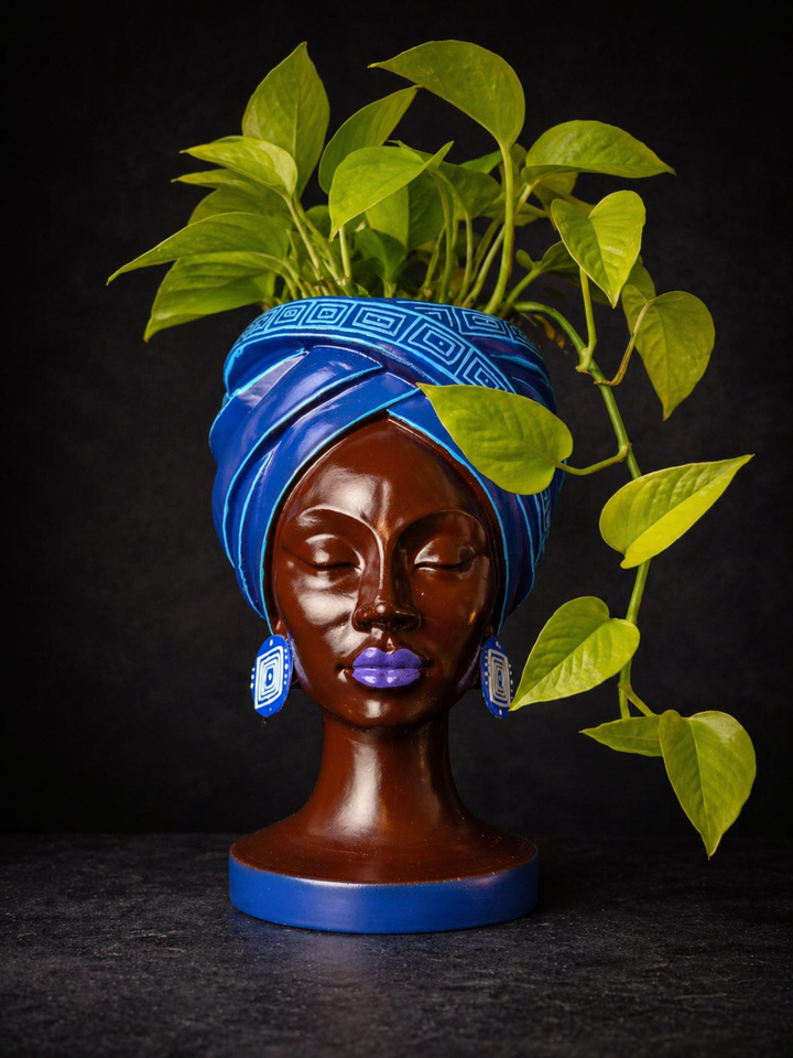 Adire Night cast stone head planter with trailing green plant by Ripleys Nest