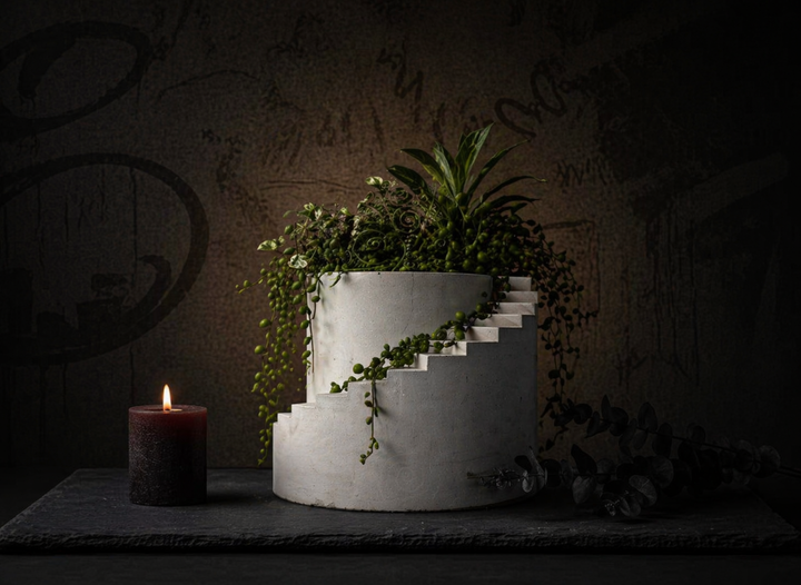 Stairwell cast stone planter with trailing planted arrangement