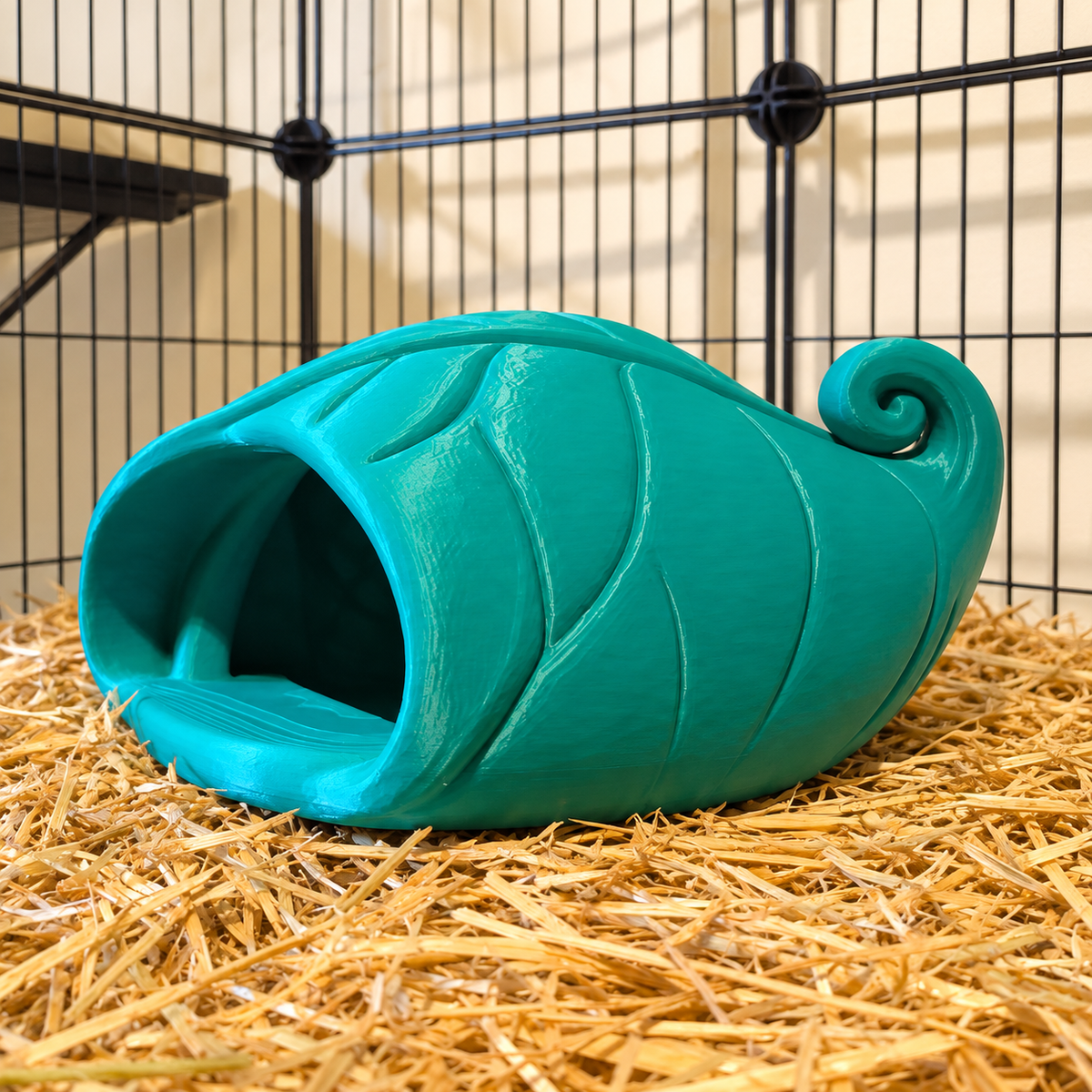 Angled side view of the teal-green leaf floor hide, showing raised veins and its curled tip.