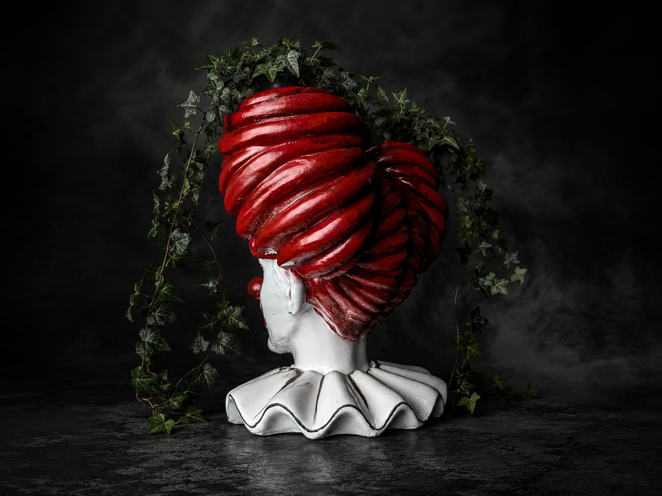 Back view of The Last Laugh planter showing sculpted red hair and twin pots