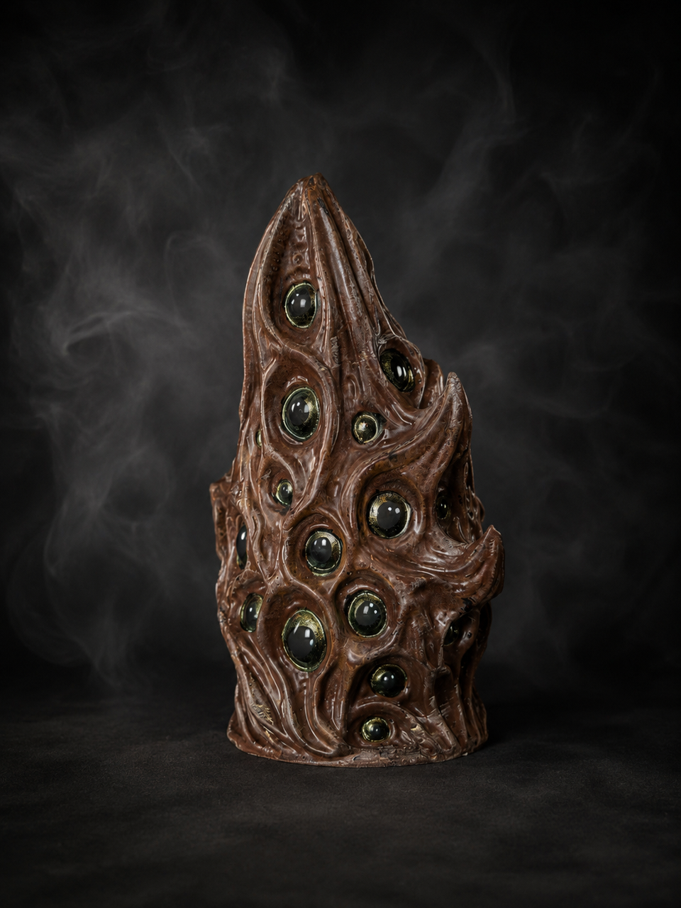 Back view of The Watching Maw showing the many-eyed cast stone surface