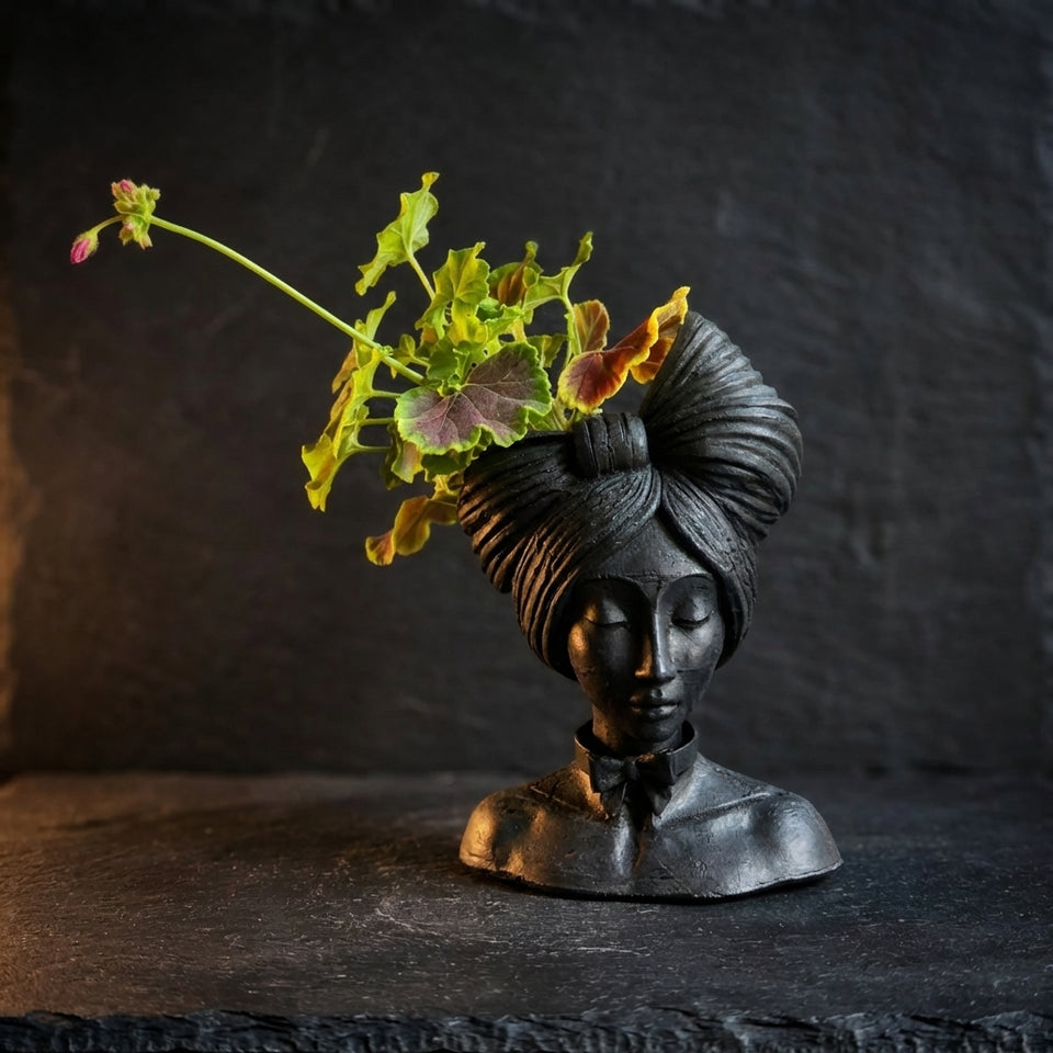 Black woman bust plant pot with greenery
