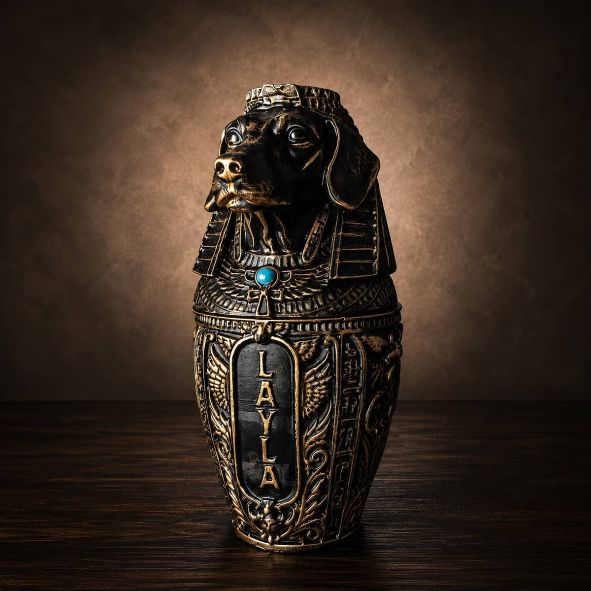 Close angled view of black and gold cast stone dog canopic urn