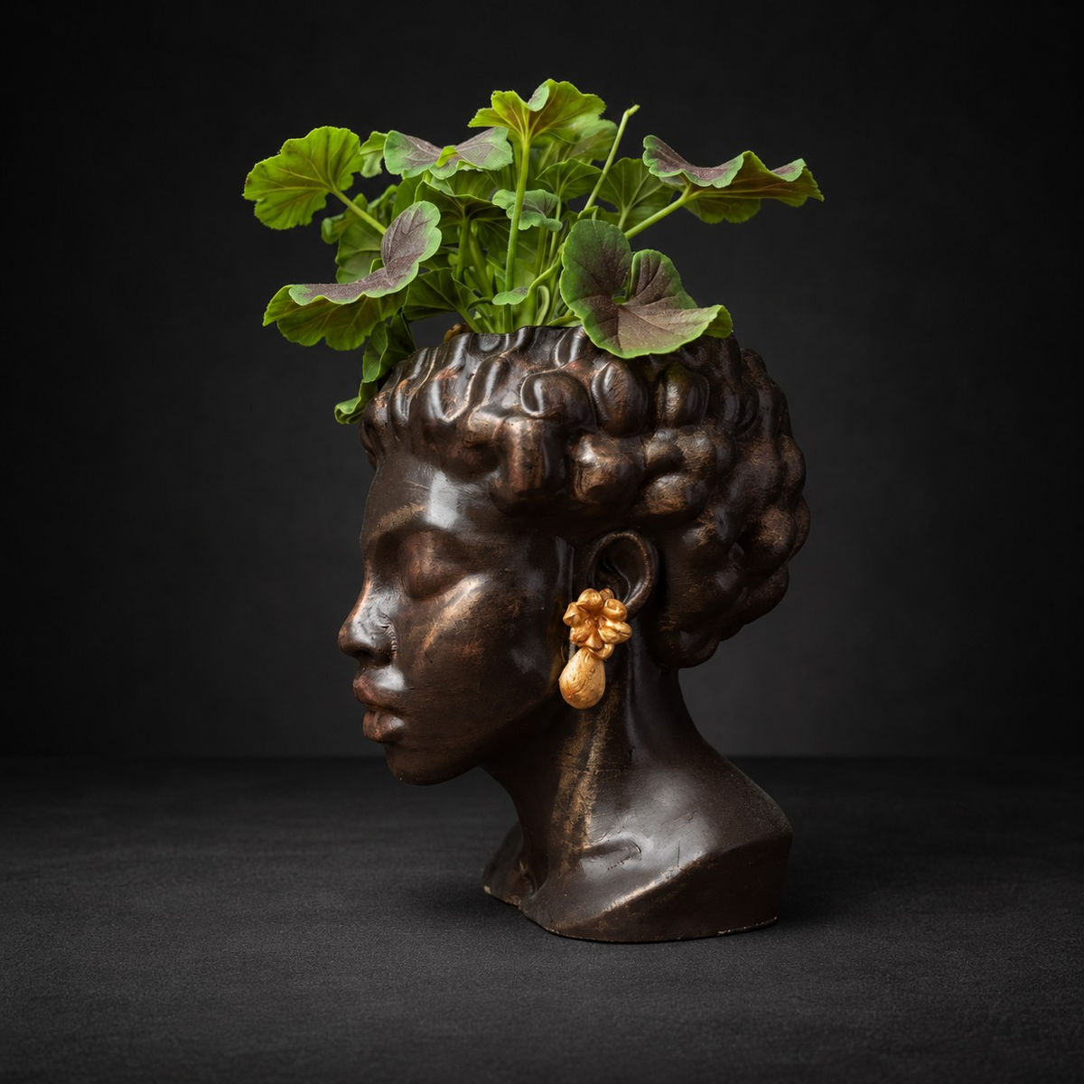 Cast stone bust planter with sculpted curly hair, right profile view