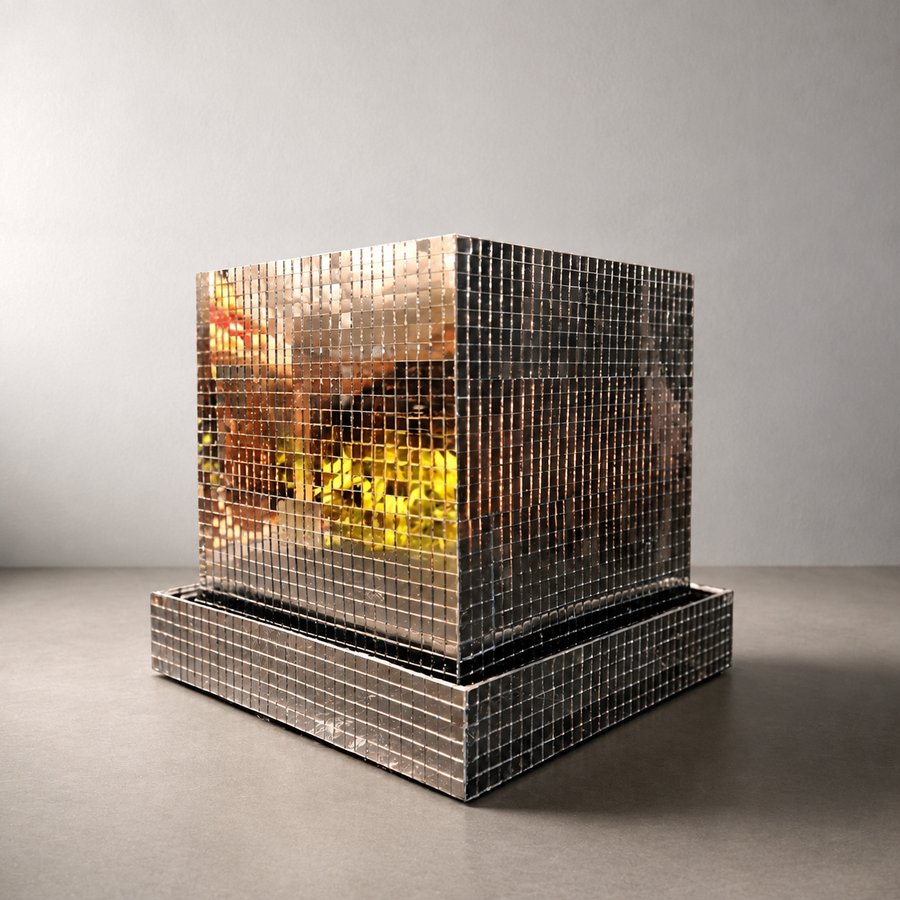 Mirror tile disco cube planter with square drainage tray on a warm-grey tabletop