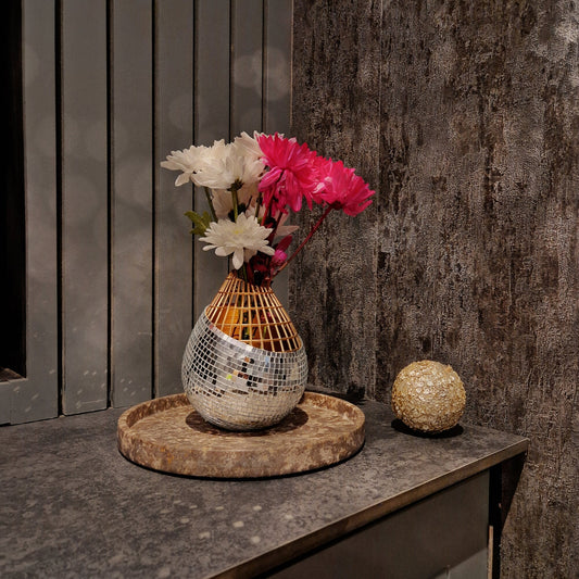 a close up of a vase with flowers in it 