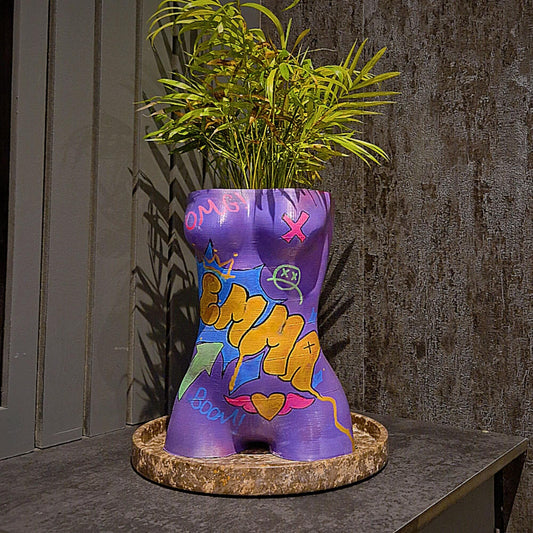 a purple vase filled with purple and purple flowers 