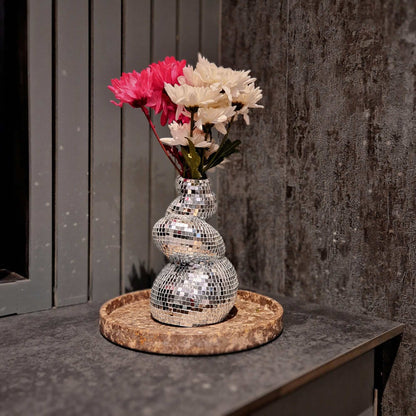 a close up of a vase with flowers in it 