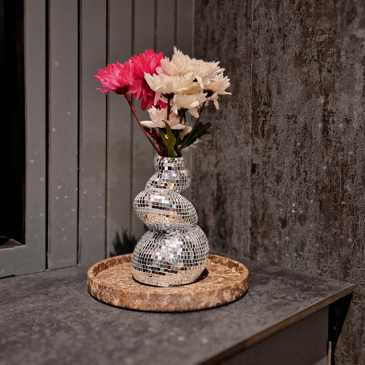 a close up of a vase with flowers in it 