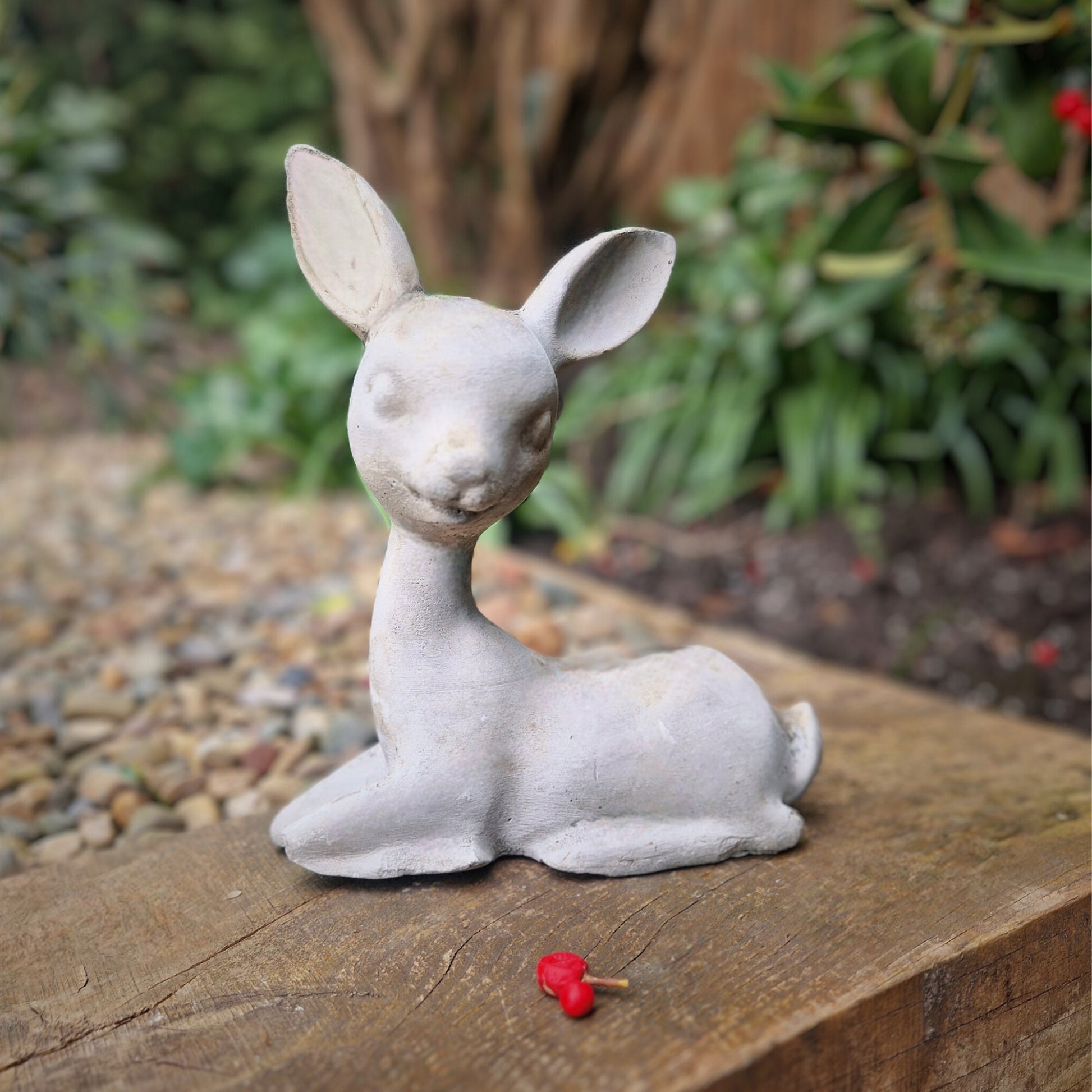 a small white dog sitting on a bench 