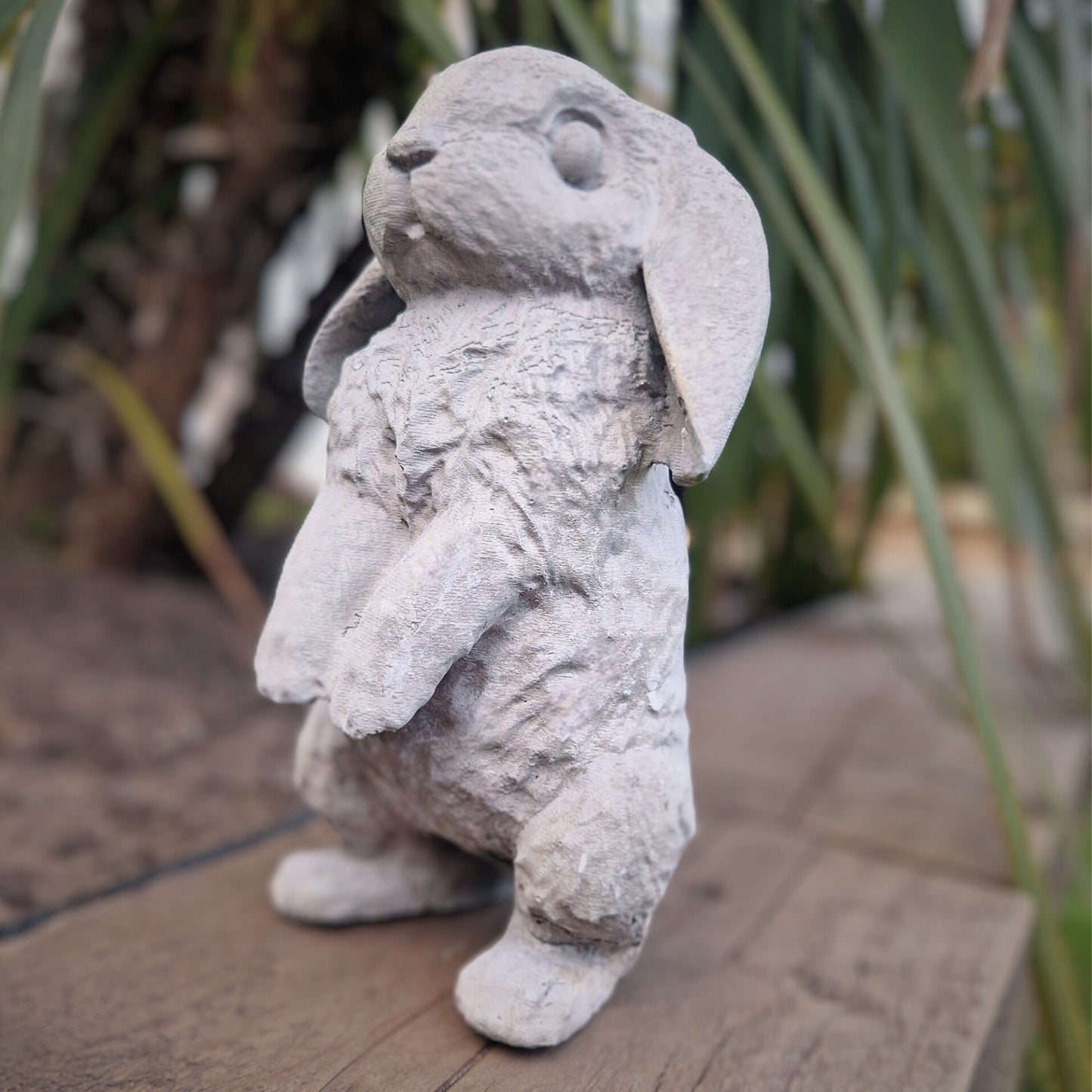 a stuffed animal is sitting on a wooden bench 