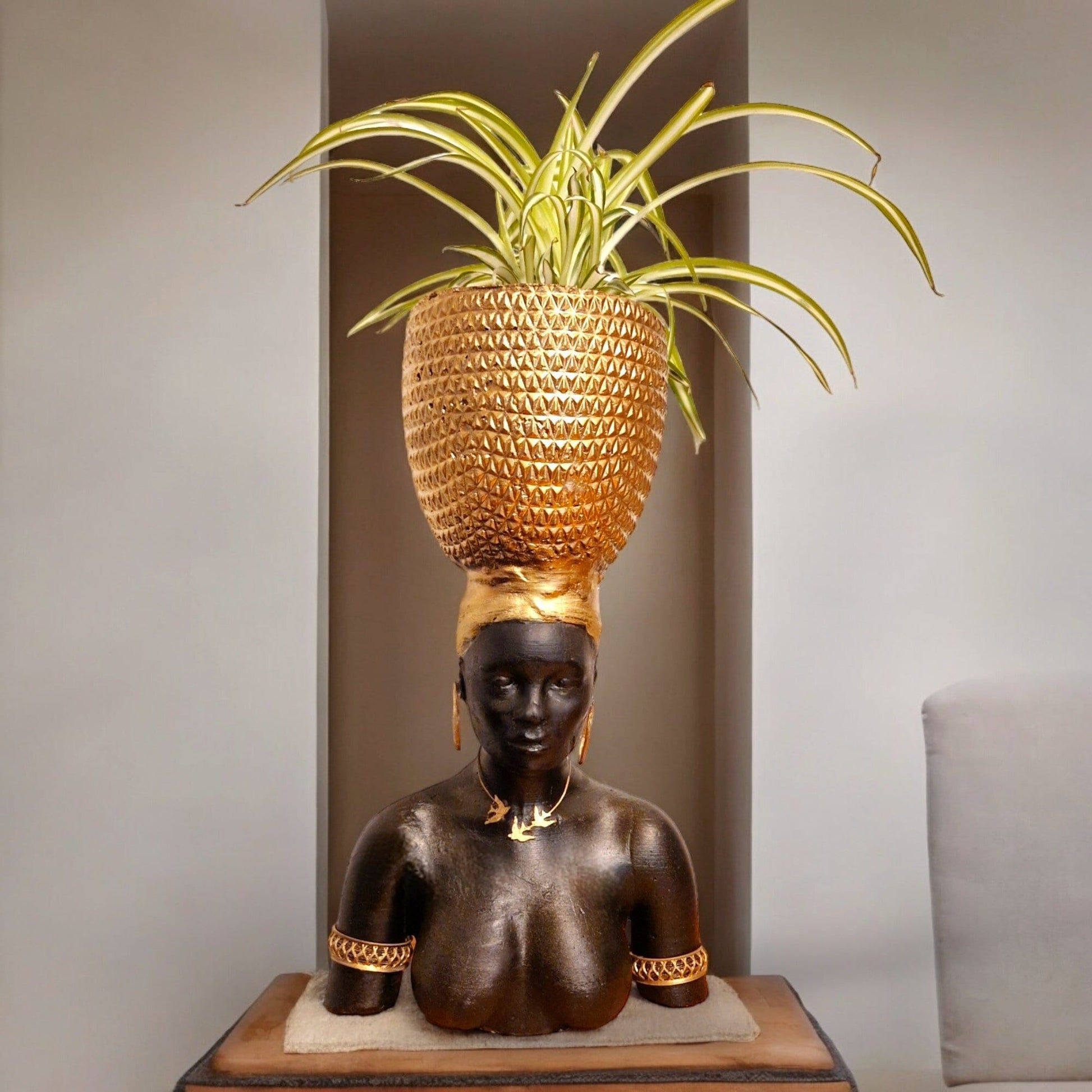 a statue of a man sitting on a wooden table 