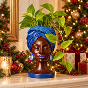 Adire Night cast stone head planter with trailing green plant by Ripleys Nest
