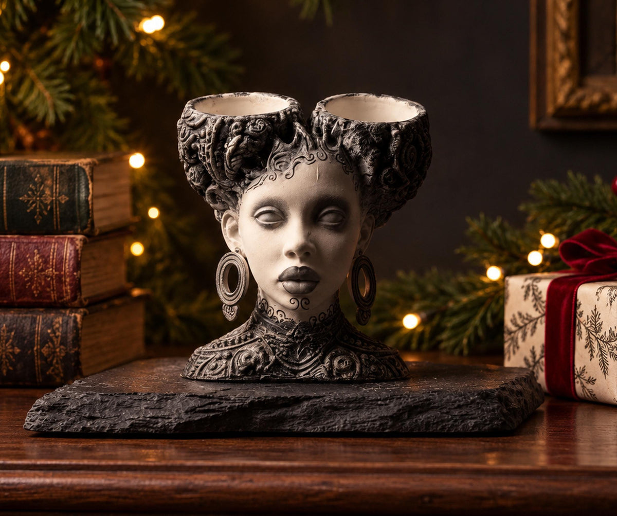 Necronomia head planter on a dark shelf with Christmas lights and wrapped gifts