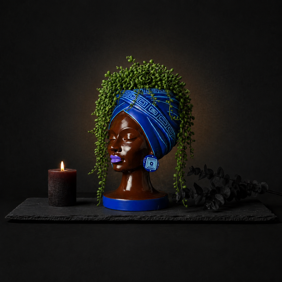 Adire Night black and gold head planter with plant and candle