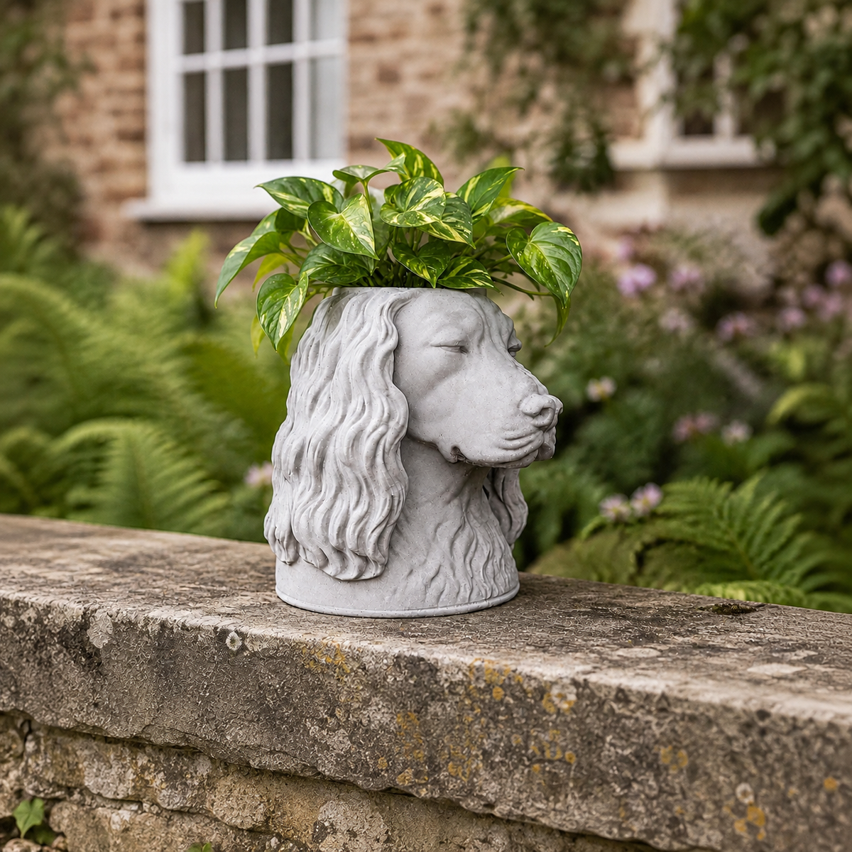 Custom stone dog planter displayed outdoors in a garden