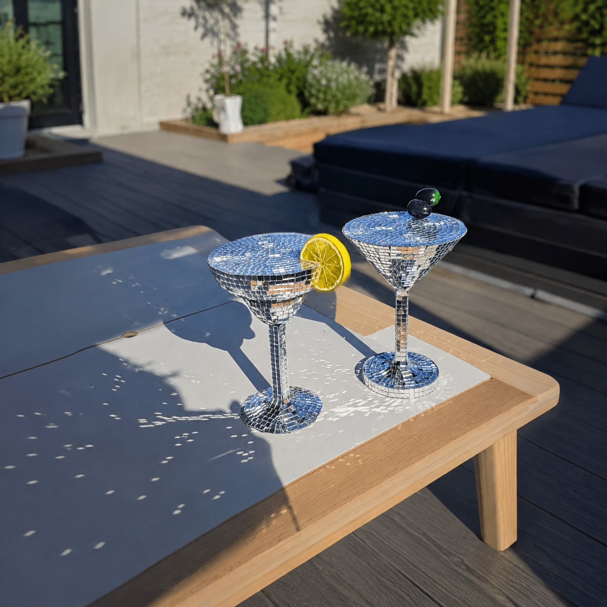 Silver mirror margarita and martini glasses outdoors