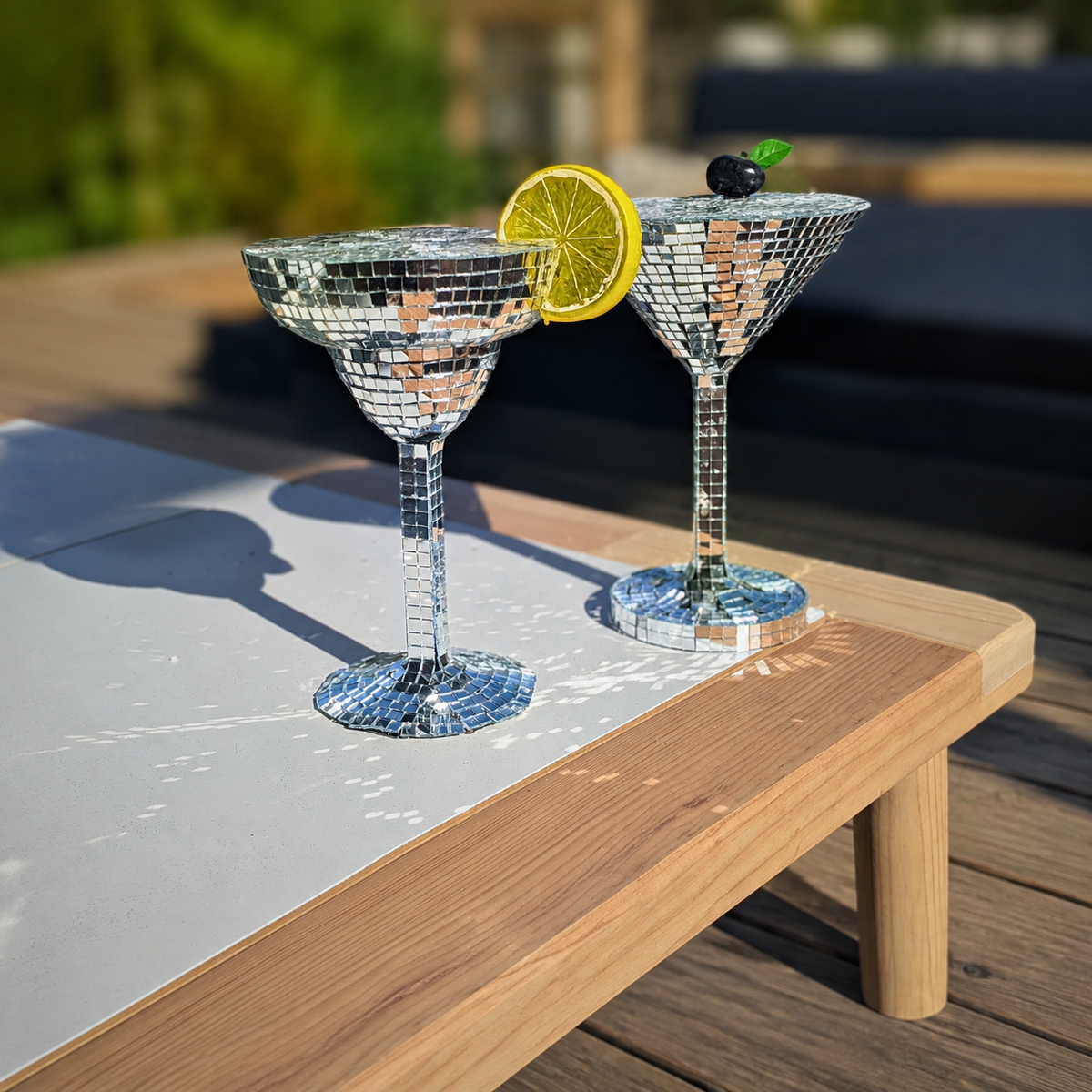 Close-up of silver mirror margarita and martini glasses outdoors