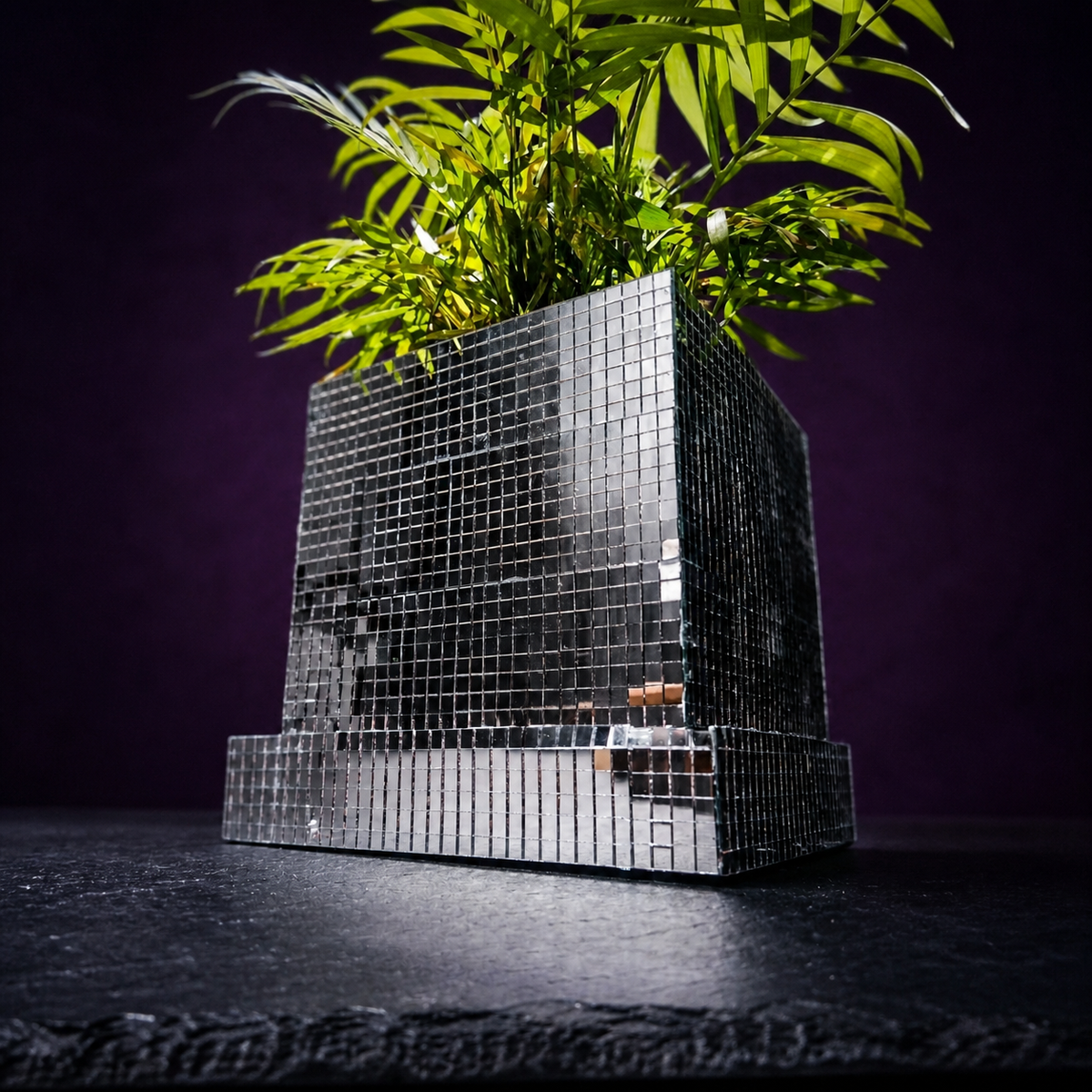 Close-up of mirror tile disco cube planter with palm fronds