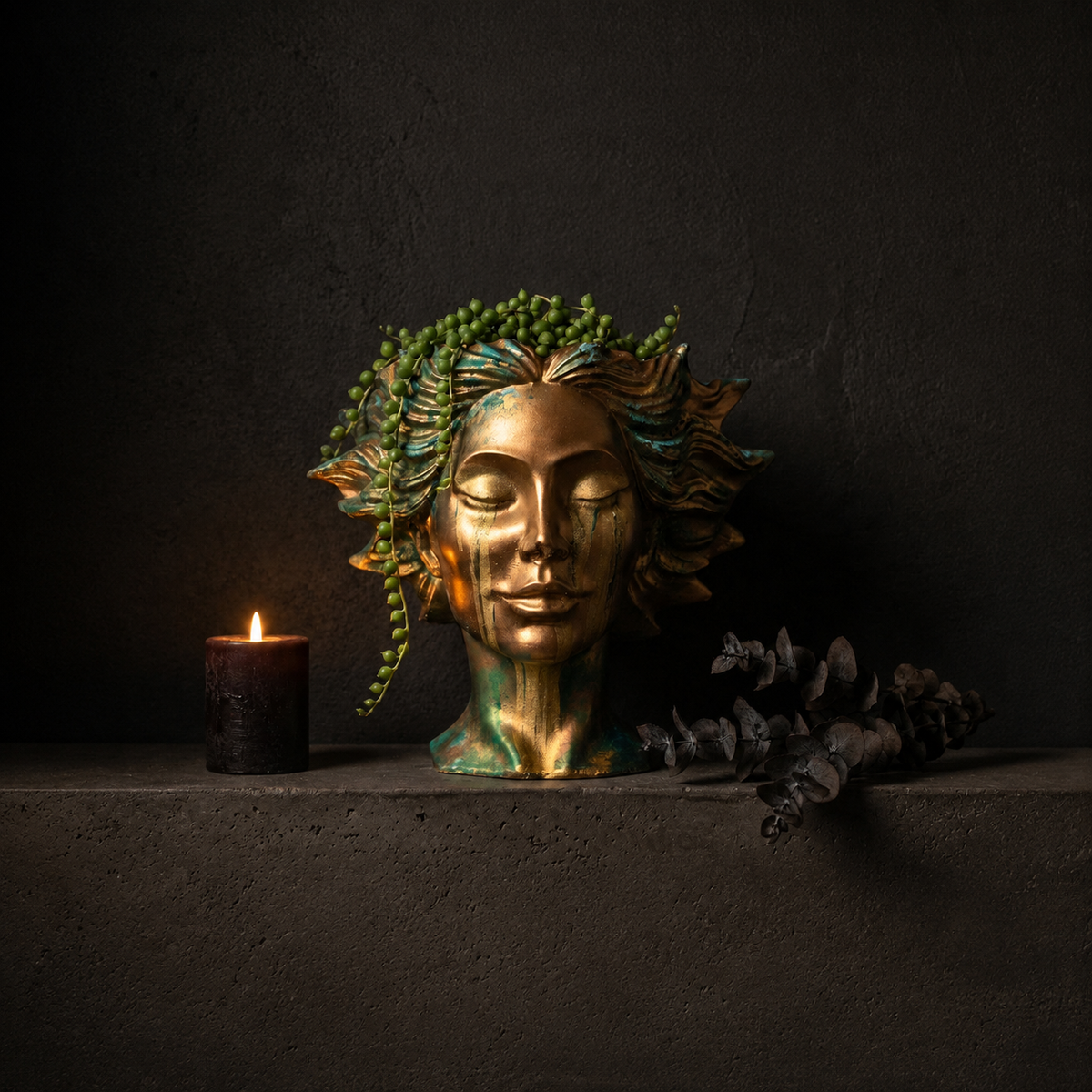 Golden Tears head planter styled on dark shelf
