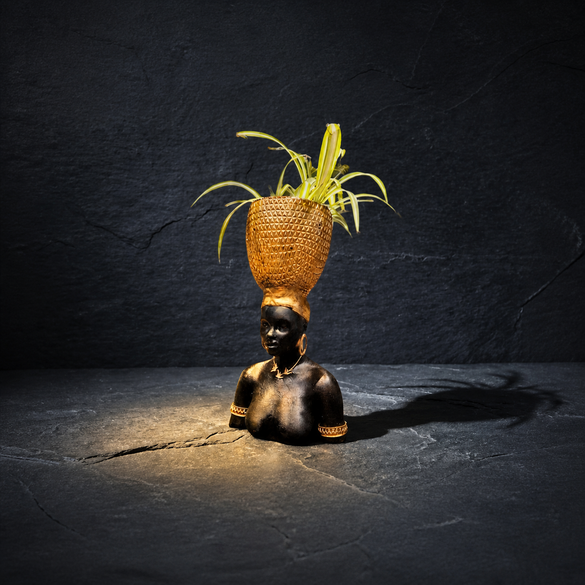 Harvest Goddess planter with spider plant on a textured stone surface