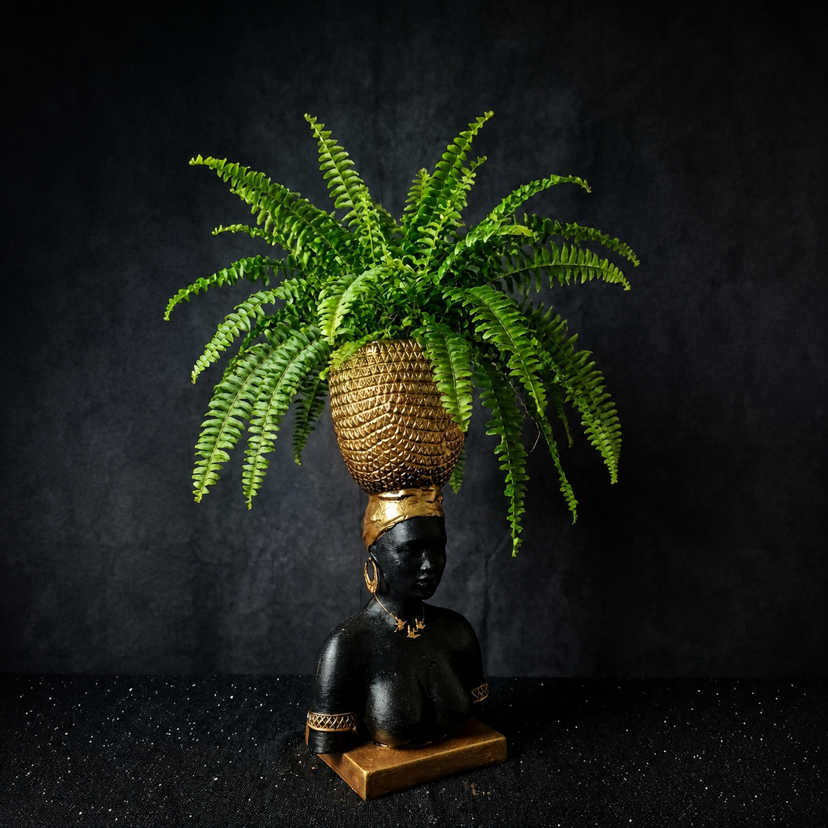 Harvest Goddess cast stone planter displayed with a trailing fern