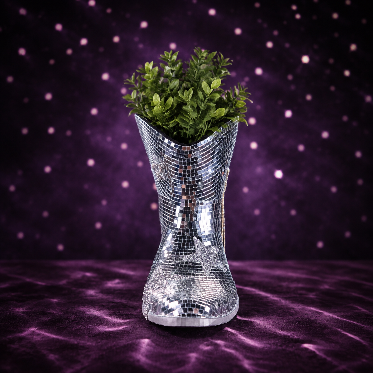 Front view of the empty mirror-tile cowboy boot planter against purple light scatter