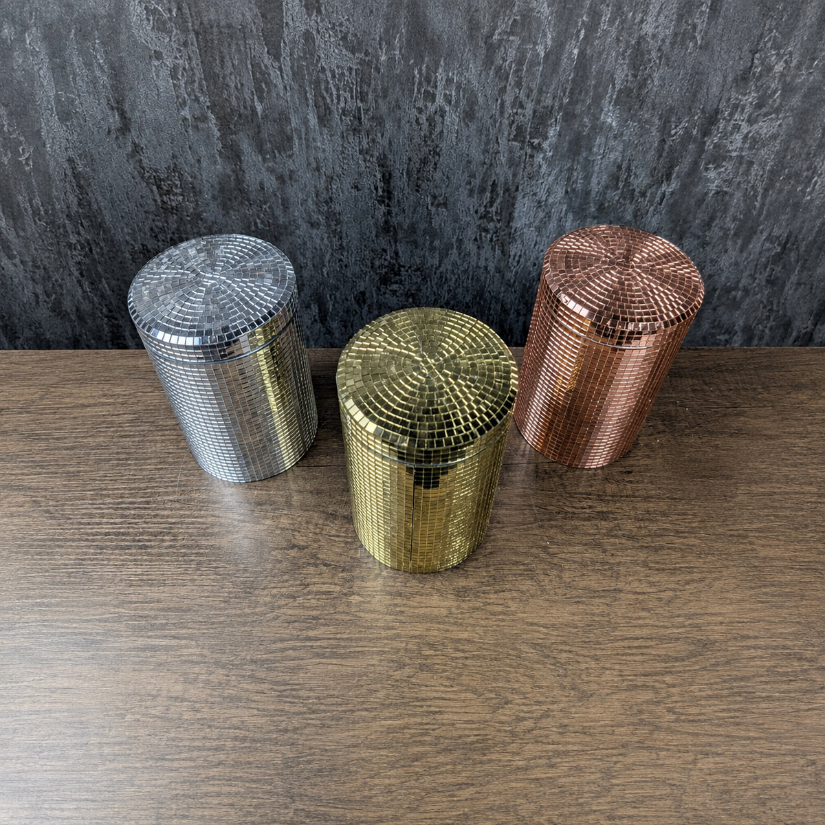 Three mirror-tiled kitchen canisters angled to show gold, rose gold and silver finishes